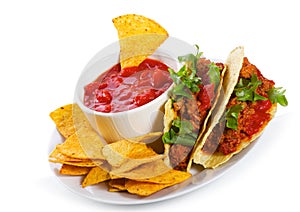 Plate with taco, tortilla chips and tomato dip