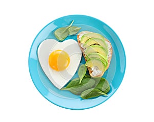 Plate of tasty breakfast with heart fried egg isolated on white, top view