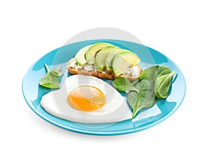 Plate of tasty breakfast with heart shaped fried egg isolated