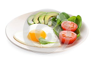 Plate of tasty breakfast with heart shaped fried egg isolated on white