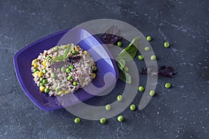 Plate with tasty brown rice and vegetables on a dark background. The concept of vegetarian food. Organic foods and fresh