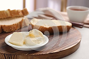Plate with tasty butter and fresh bread
