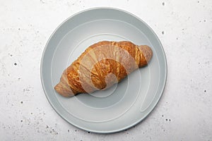 Plate with tasty croissants on stone background. French pastry