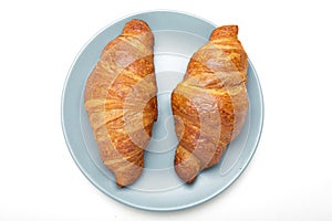 Plate with tasty croissants on white background. French pastry