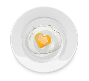 Plate with tasty fried egg with yolk in shape of heart on white background, top view