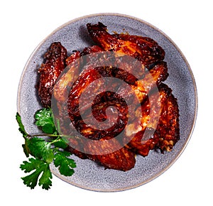 Plate of tasty snack - roasted chicken wings closeup