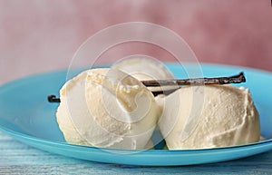 Plate with tasty vanilla ice cream on table , closeup