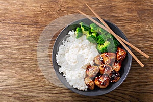 Plate of teriyaki chicken, broccoli and rice, top view