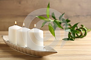 Plate with three candles and bamboo branch. Space for text