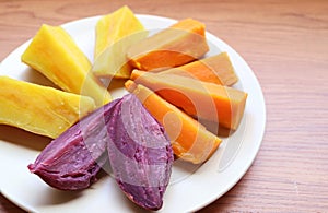 Plate of three different color steamed sweet potatoes photo