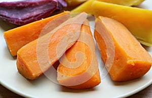 Plate of three different color steamed sweet potatoes, a good source of healthy carbs