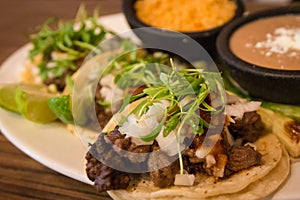 Plate of three street style tacos photo