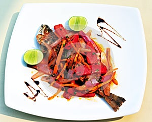 plate of Tollo NorteÃ±o fried with tomato sauce and onion with lemon photo