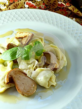 Plate of tortelli with ceps in a mushrooms sauce photo