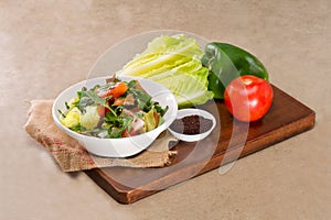 Plate of traditional Arabic salad fattouch on a wooden plate