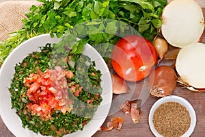 Plate of traditional Arabic salad tabbouleh on a wooden plate