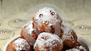 Plate with traditional Dutch oliebollen, deep-fried raisin bun, close up