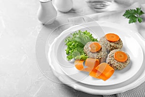 Plate of traditional Passover Pesach gefilte fish on grey background