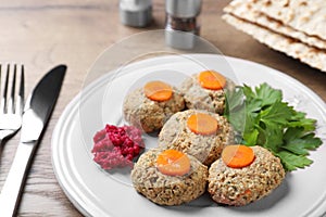 Plate of traditional Passover Pesach gefilte fish on wooden table