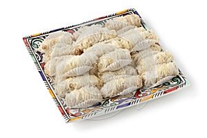 Plate with traditional patisserie Moroccan almond cookies isolated on white background