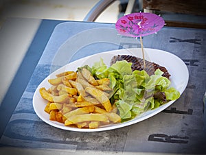 plate of traditional schnitzel with potato fries on restorant