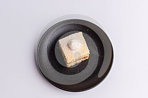 a plate with two squares of cake on it next to a jar of milk