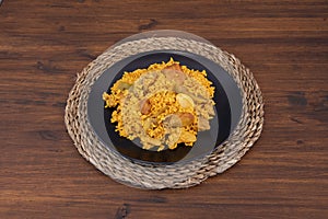 Plate of Valencian paella with vegetables and chicken, garrafon beans, artichokes photo