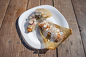 Plate with variety of mexican food.tamal, taco and gordita stuffed