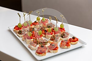 Plate with various seafood and meat canapes