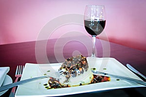 Plate of vegan food with glass of wine