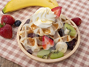 Plate of waffles with  fresh  fruits