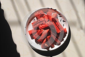 A plate of watermelon slices in a white plate, frut photo