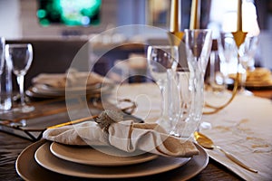 A plate on which lies a white napkin, empty glass goblets on the table