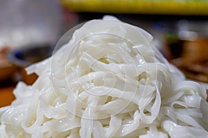 A plate of white Chinese fresh rice noodles, freshly cut hor noodles