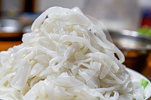 A plate of white Chinese fresh rice noodles, freshly cut hor noodles