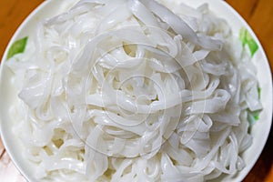 A plate of white Chinese fresh rice noodles, freshly cut hor noodles