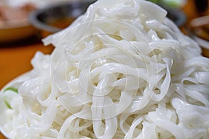 A plate of white Chinese fresh rice noodles, freshly cut hor noodles