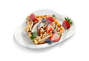 Plate with yummy waffles, berries and ice cream on white