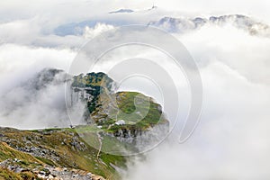 The plateau of Chlus with hiking paths at the Schaefler in Alpstein surrounded by the rising fog photo