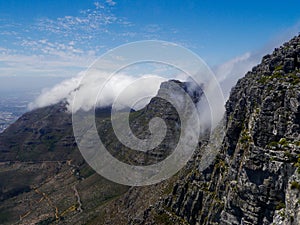 The plateau of Table Mountain in Cape Town is covered in clouds