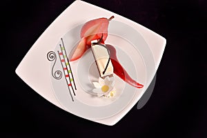 Plated dessert with poached pears in white porcelain plate