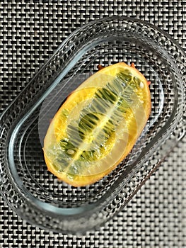 A Plated Horned Melon or Kiwano, also the African Horned Cucumber, Jelly Melon, Hedged Gourd, or Melano is a Beautiful Fruit photo