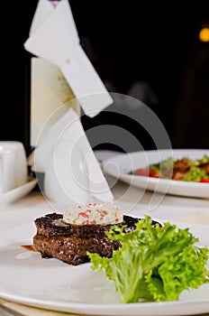 Plated Meal of Steak Topped with Herbed Butter