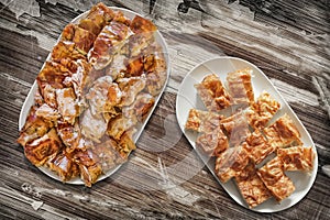 Plateful Of Cheese Pie Gibanica and Spit Roasted Pork Meat Slices Set On Old Garden Table photo
