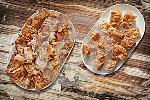 Plateful Of Cheese Pie Gibanica and Spit Roasted Pork Meat Slices Set On Old Garden Table photo
