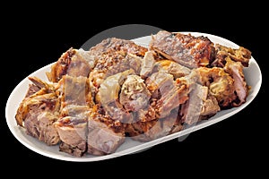 Plateful of Freshly Spit Roasted Pork Thigh Crispy Crackling Meat Slices on Oval Porcelain Tray Isolated on Black Background