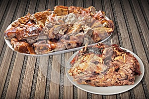 Plateful Of Gourmet Spit Roasted Pork Slices And Well Done Juicy Pork Ham Set On Rustic Bamboo Mat