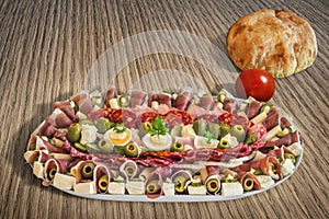 Plateful Of Traditional Serbian Appetizer Dish Meze With Pitta Bread And Tomato Set On Wooden Table Surfac photo