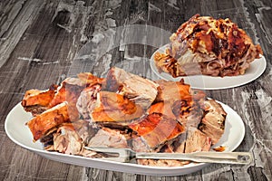 Plateful Of Spit Roasted Pork Ham And Shoulder Slices Set On Old Cracked Garden Table