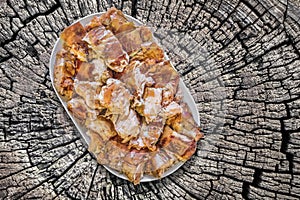 Plateful Of Spit Roasted Pork Meat Slices Set On Old Weathered Cracked Stump Picnic Table